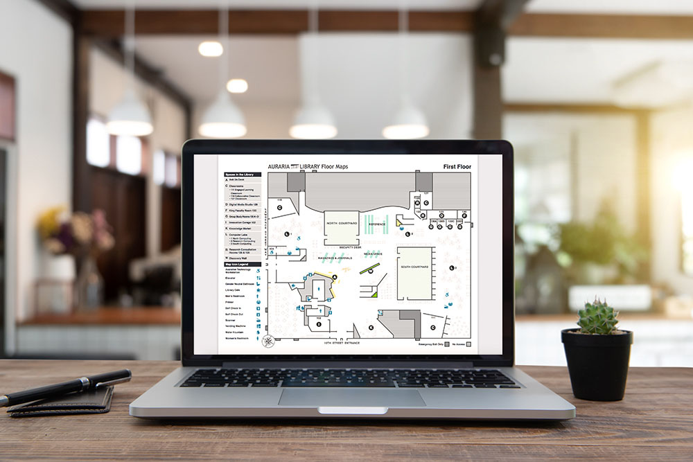 Inviting office desk with a laptop screen showing the new map design